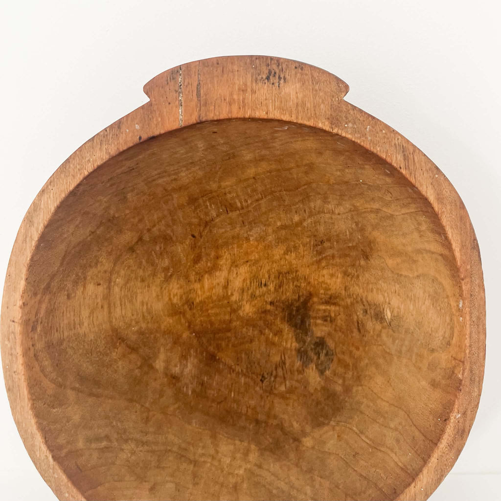 Rustic antique wooden dough bowl with small carved handles, natural aged wood grain and beautiful brown patina, ideal for farmhouse décor