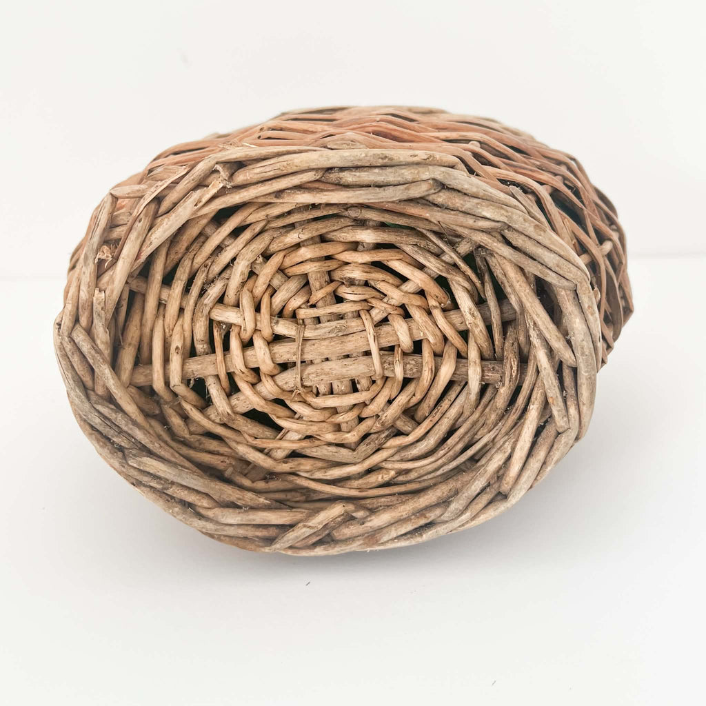 Rustic wicker-covered glass wine bottle with a naturally aged appearance, perfect for farmhouse, Scandinavian and coastal home interiors