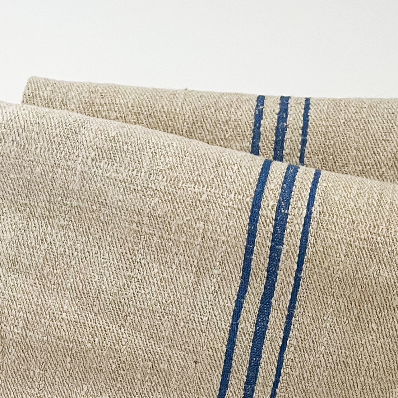Antique grain sack with blue stripes