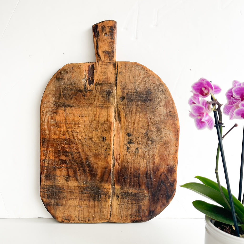 Solid wood farmhouse charcuterie board with natural cracks and patina