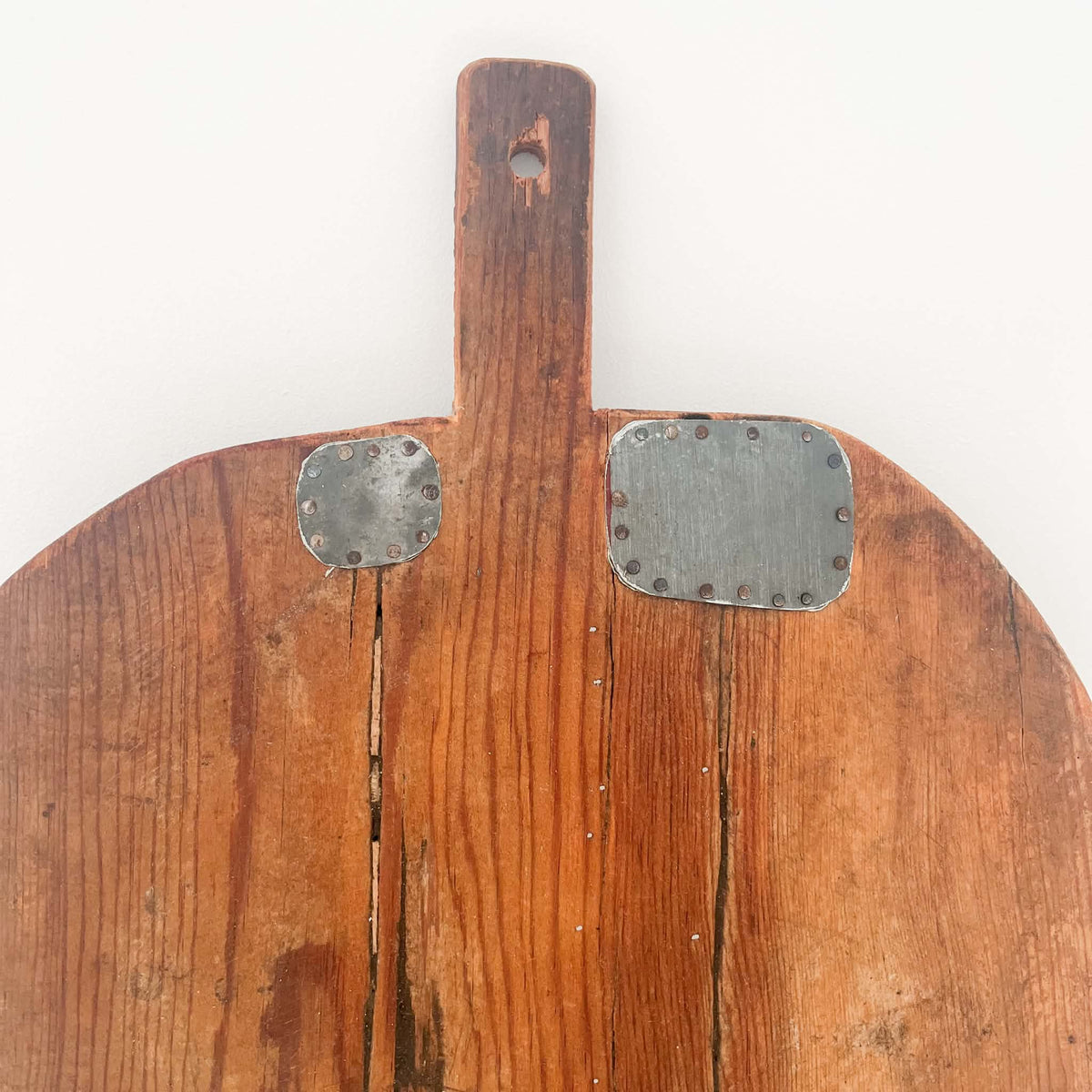 Hand-carved antique European bread board made from a single piece of solid wood, with natural knife marks and aged patina