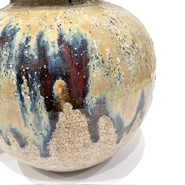 Close-up of textured rustic clay and multicolored glaze on vintage Japanese vase